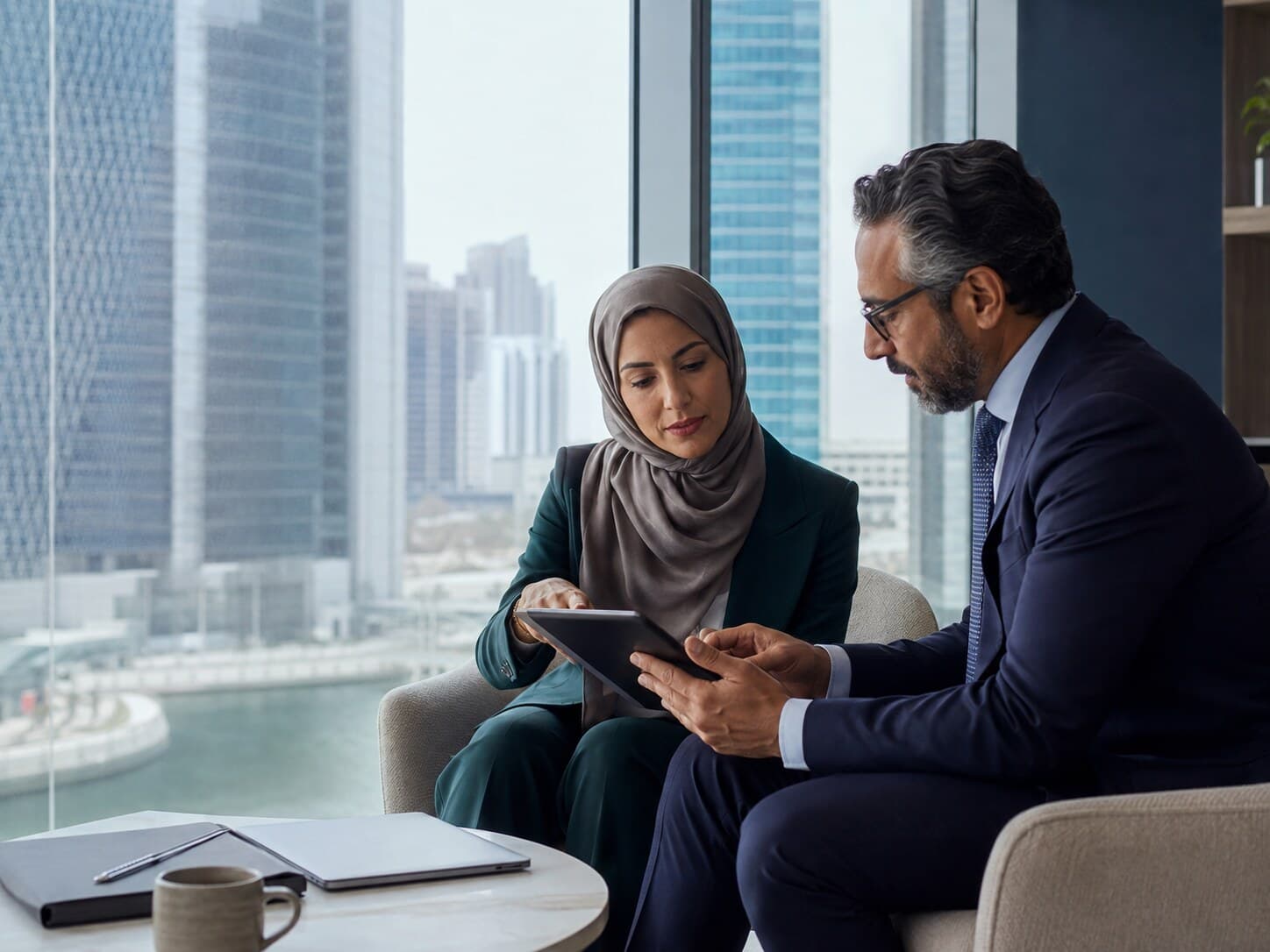 Business advisers reviewing a company profile in Abu Dhabi